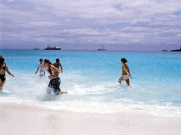 Wading in the surf along the beautiful white sand beaches of Bartolome Island